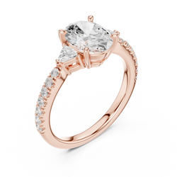 Angle 2 Side Cathedral Profile View: Detailed side profile of the 14K solid gold 3 stone engagement ring revealing the handcrafted collet basket setting holding the oval center stone, trillion accent diamonds, and smooth high polish finish of the under basket for optimal sparkle and comfort.