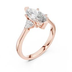 Side profile angle of a solid 14K Gold three stone engagement ring highlighting the sleek collet basket craftsmanship and the brilliant symmetry of the Marquise and Trillion Cut lab grown diamonds.