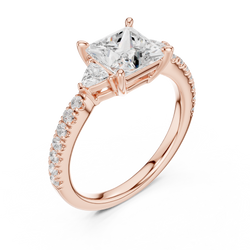 Side profile angle of an 18K Gold Lab Diamond Engagement Ring detailing the three stone basket setting with raised prongs, custom gallery understructure, and elegant side accent diamonds crafted to capture maximum light and fire for luxury anniversary gifts and wedding celebrations.