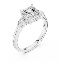 Three stone Asscher cut lab grown diamond engagement ring presented elegantly inside a premium black velvet jewelry ring box ready for romantic wedding proposal or anniversary gift giving.