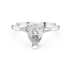 Angle 5 Top Down Overhead Perspective capturing the classic 3 stone symmetry and outline of the pear cut and dual tapered baguettes set in high polish solid gold ring construction.

