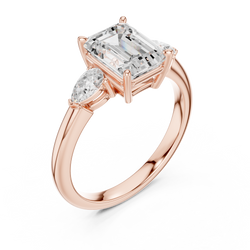 Angled side studio perspective showing the elevated 5.35mm crown height and intricate peg head design of a 14K Gold 3 Stone Emerald Cut Lab Grown Diamond Ring with smooth high polish finish.