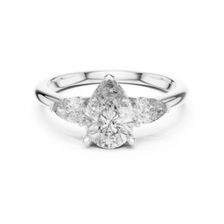Bottom shank band and hallmark engraving detail perspective photo of a handmade 14K solid gold pear cut diamond engagement ring displaying authentic metal karat stamp and expert polish finish.

