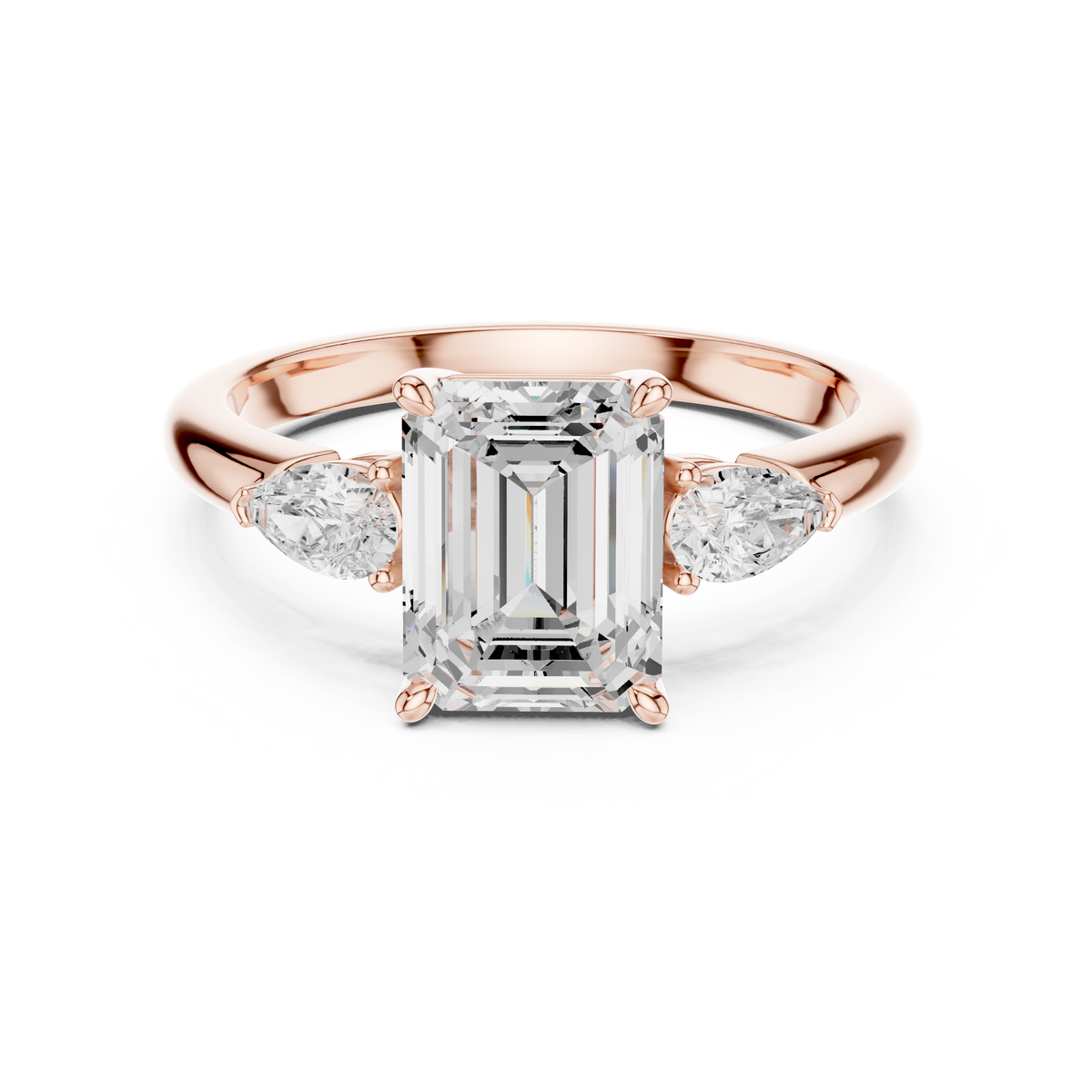 Front top down view of a 14K Gold Emerald Cut Lab Diamond 3 Stone Engagement Ring featuring a 2.00 Carat 8.50x6.50mm central emerald cut stone flanked by two brilliant pear cut side stones set in four prong baskets.