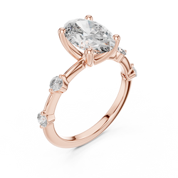 Side profile view showing the cathedral setting of this oval lab diamond solitaire ring in solid 14k white gold, detailing the 4 prong crown and round accent stones along the shoulder bridge.

