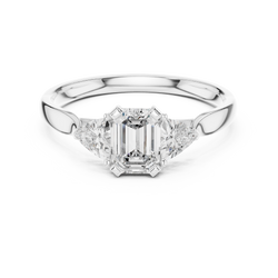 Top down isometric CAD view displaying the precision geometry of the three stone arrangement with emerald cut center diamond and side trillion diamonds.

